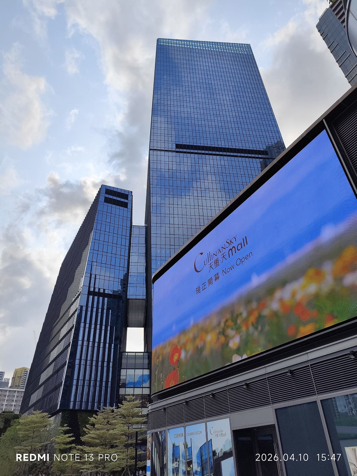 Outdoor LED display mounted high on the glass facade of a commercial tower